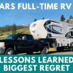 A photo of a black truck and small 5th wheel beside the road in front of a green hill. Background has a low mountain with snow on the right and forested hills on the left. Text says "5 years full-time RV life. Lessons learned and biggest regret."