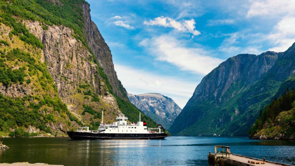 ship arriving at the narrow end of fjord in Norway