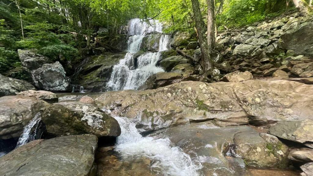 Cascading waterfall spilling into a natural rock pool